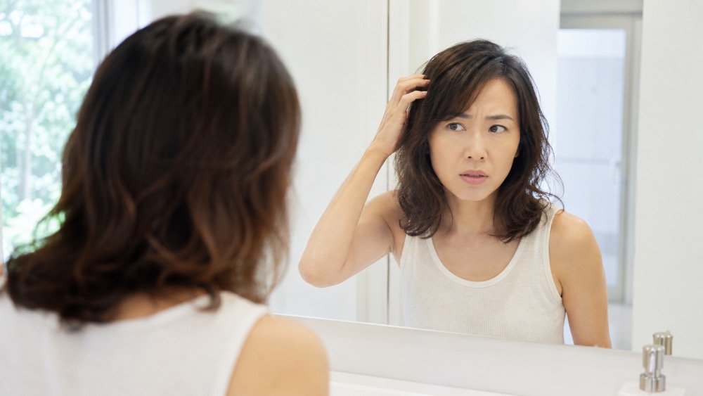 鏡を見て戻ってきた髪のクセに戸惑う女性